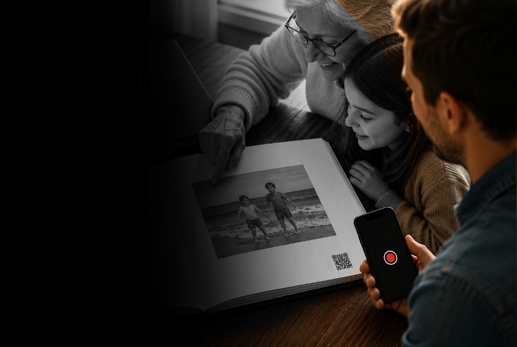 Family gathered around a hardcover memory album — grandmother, granddaughter, and father capturing the moment